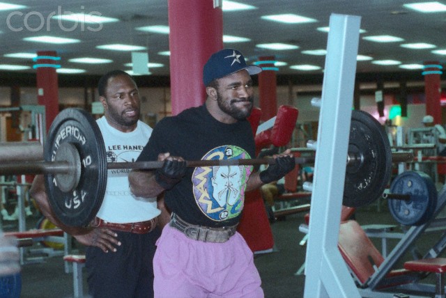 Houston, Texas, USA — Heavyweight boxer Evander Holyfield lifts weight with the help of Olympic weight lifter Lee Haney. This is part of Holyfield’s training for an upcoming fight. — Image by © Michael Brennan/CORBIS