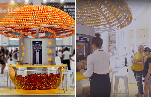 Машина, отжимая сок, перерабатывает апельсиновые корки в стаканчики